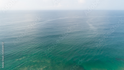Aerial view of mystery sea surface under blue sky