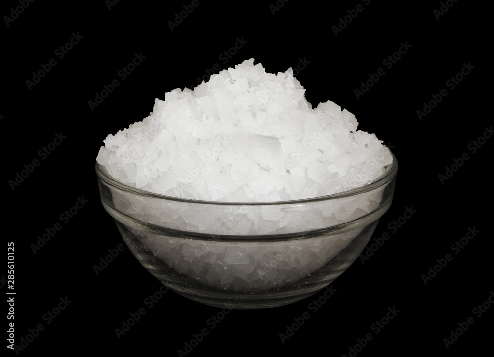 Coarse organic sea salt in bowl isolated on black background Coarse organic sea salt in bowl isolated on black background