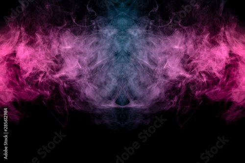Smoke of different blue  red and pink colors in form of horror in the shape of the head  face and eye with wings on a black isolated background. Soul and ghost in mystical symbol. Print for clothes.