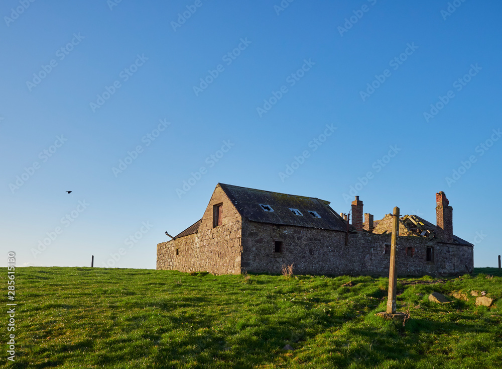 Derelict and Abandoned Farm Building at Usan on a Bright Spring Day in March, with its Roof Timbers visible, Montrose, Scotland.