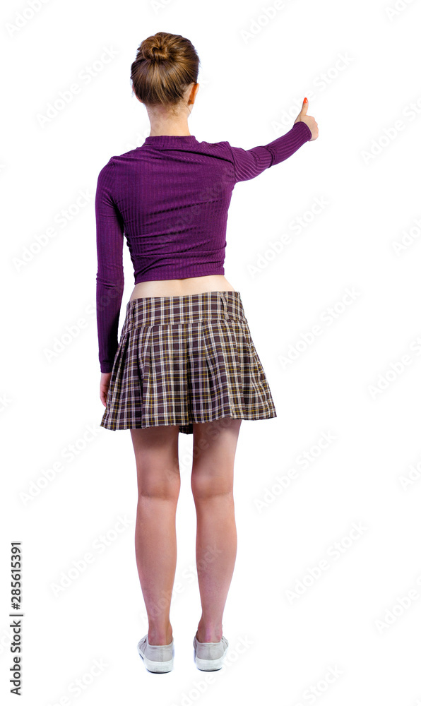 Fototapeta premium Back view of a woman showing thumb up.