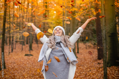Casual young woman enjoying autumn season at forest