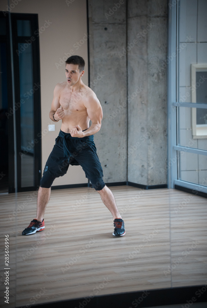 An athletic man boxer training in the studio