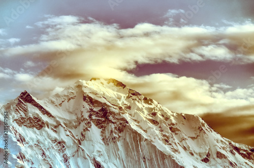 Clouds over the Ladyfinger peak in the Karakoram mountains range  photo