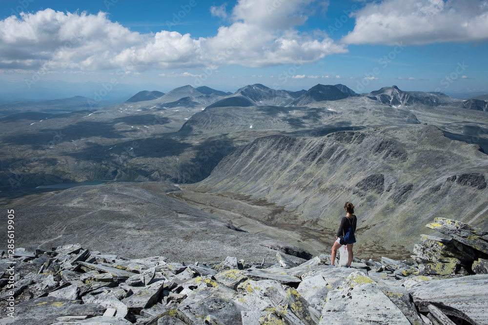 Woman standing on rocky top of Storronden, Rondane National Park, Norway