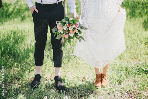 Bride and groom feet close up. Rustic wedding concept.