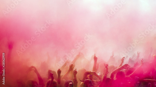 Red and pink holi colors over the crowd