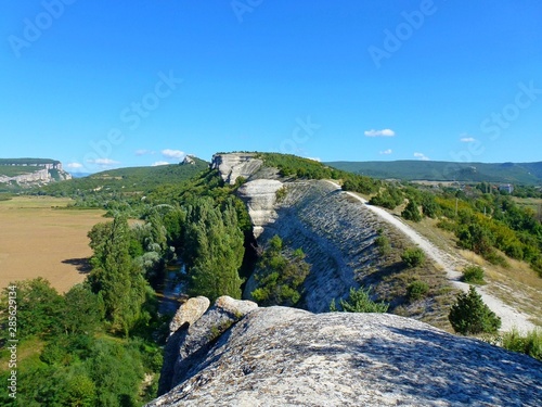 Panorama from the cave fortress city of Mangup to the Chernaya River and Tatar settlements and other mountains of Crimea, view from Mount Crocodile photo