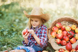 Girl with Apple in Apple Orchard. Beautiful Girl Eating Organic Apple. Harvest Concept.