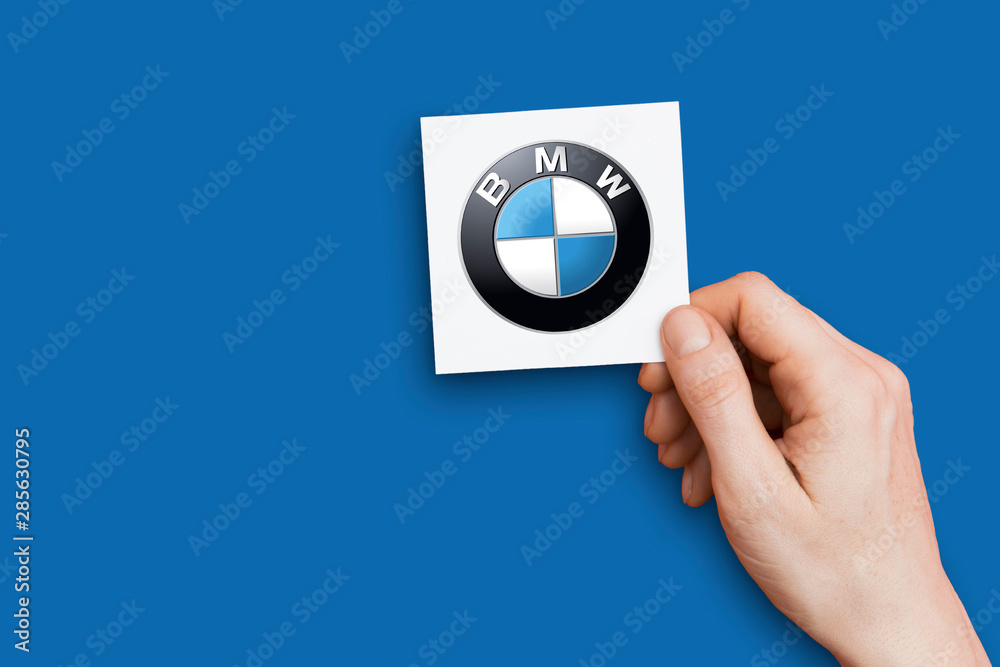 LONDON, UK - October 26th 2018: Hand holding a BMW logo. BMW is an  automobile manufacturer. Stock Photo