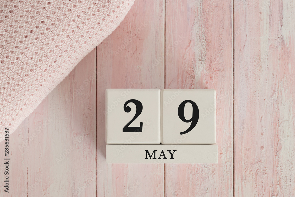 29 May Date on Cubes. Date on painted pink wood, next to baby blanket. Theme of baby due dates and birth dates. 29 May Date on Cubes. Date on painted pink wood, next to baby blanket. Theme of baby due dates and birth dates.