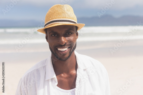 Man standing at beach on a sunny day