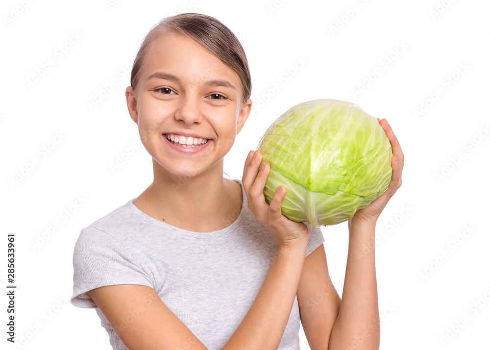 Beautiful young teen girl holding fresh green cabbage, isolated on white background. Portrait of smiling child showing delicious healthy raw vegetables in hands. Organic natural healthy food produce. Beautiful young teen girl holding fresh green cabbage, isolated on white background. Portrait of smiling child showing delicious healthy raw vegetables in hands. Organic natural healthy food produce.