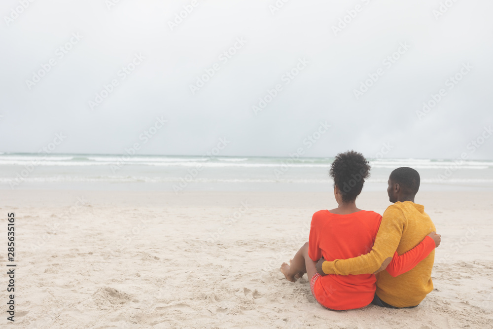 Romantic couple relaxing at beach on a sunny day