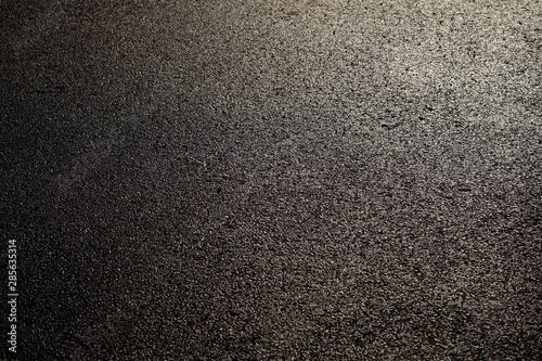 wet asphalt road with sunny texture