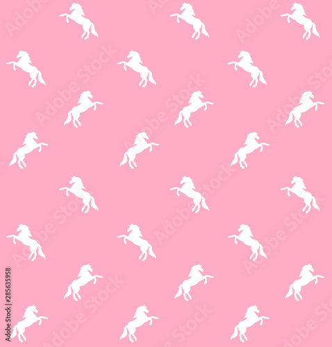 Vector seamless pattern of white unicorn silhouette isolated on pastel pink background