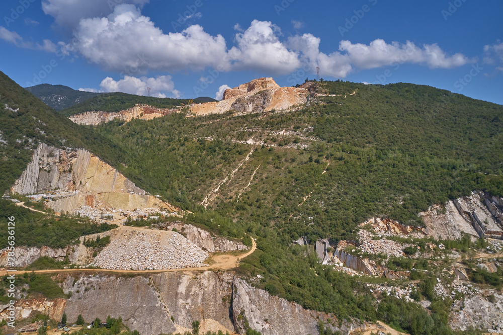Air view of a marble quarry. Panoramic view of the extraction of marble in the quarry. Technique in the marble quarry of Brescia, Italy. Open pit mine.