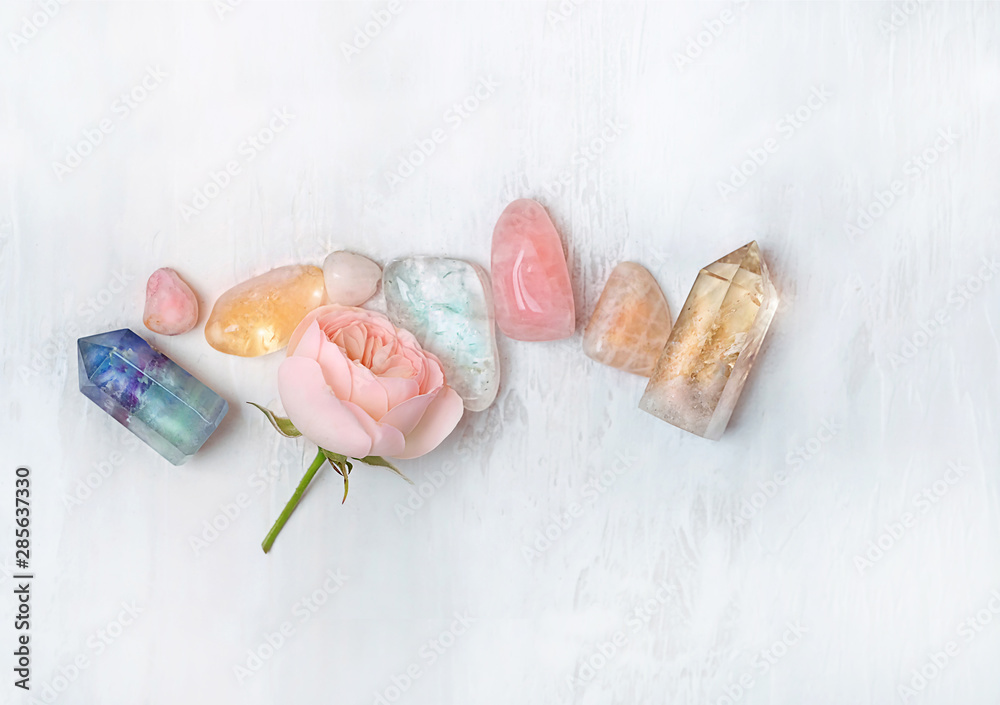 set gemstones crystal minerals for relaxation and meditation and rose flower. Magic Rock for Crystal Ritual, Witchcraft. Crystal Layout for Relaxing Chakra. Healing stones on white table. soft focus