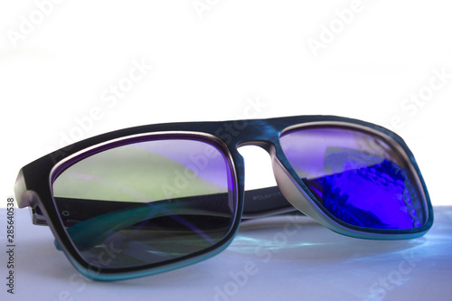  Fashionable polaroid sunglasses on a white background. Macro, purple-blue glass. gradient edging.
