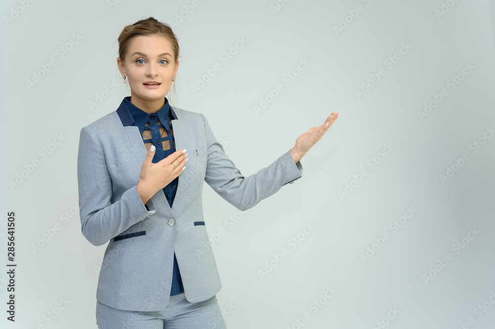 Studio photo a waist-high portrait of a pretty young woman girl in a business suit on a white background. He stands right in front of the camera, explains, with emotion. Studio photo a waist-high portrait of a pretty young woman girl in a business suit on a white background. He stands right in front of the camera, explains, with emotion.
