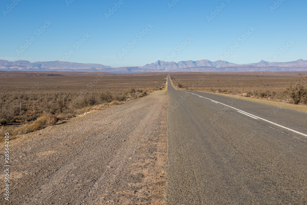 The N12 highway runs in places through the arid Klein Karoo region of South Africa image in landscape format with copy space