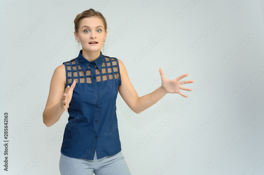 Studio photo a waist-high portrait of a pretty young woman girl in a business suit on a white background. He stands right in front of the camera, explains, with emotion. Studio photo a waist-high portrait of a pretty young woman girl in a business suit on a white background. He stands right in front of the camera, explains, with emotion.