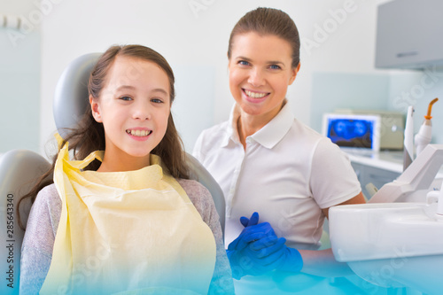 Portrait of smiling patient and dentist at dental clinic