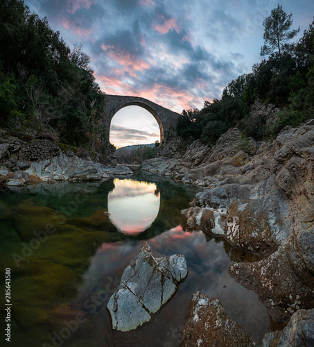 Astonishing sunset reflection of a bridge & a dramatic sky