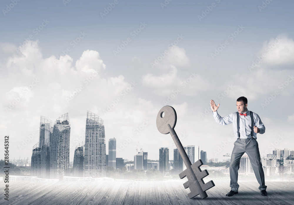 Breaking through access concept with furious man crashing concrete key Breaking through access concept with furious man crashing concrete key