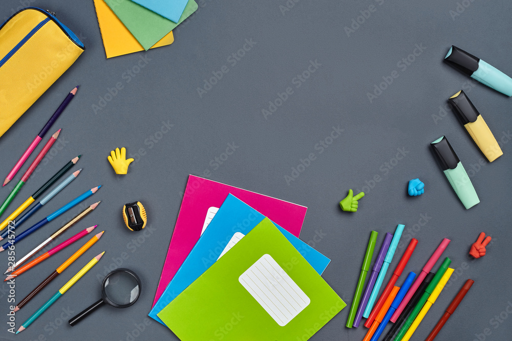 Flat lay photo of workspace desk with school accessories or office supplies on gray background. Flat lay photo of workspace desk with school accessories or office supplies on gray background.