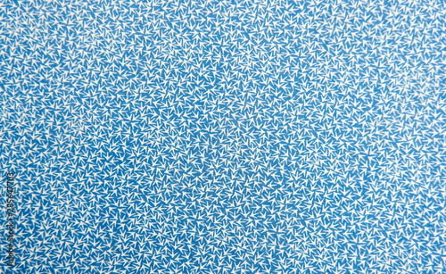 Blue fabric background texture. close up blue fabrics cloth with white arrows pattern and template for an empty surface and wallpaper. Beauty and fashion concept. Vintage white arrow for abstract.