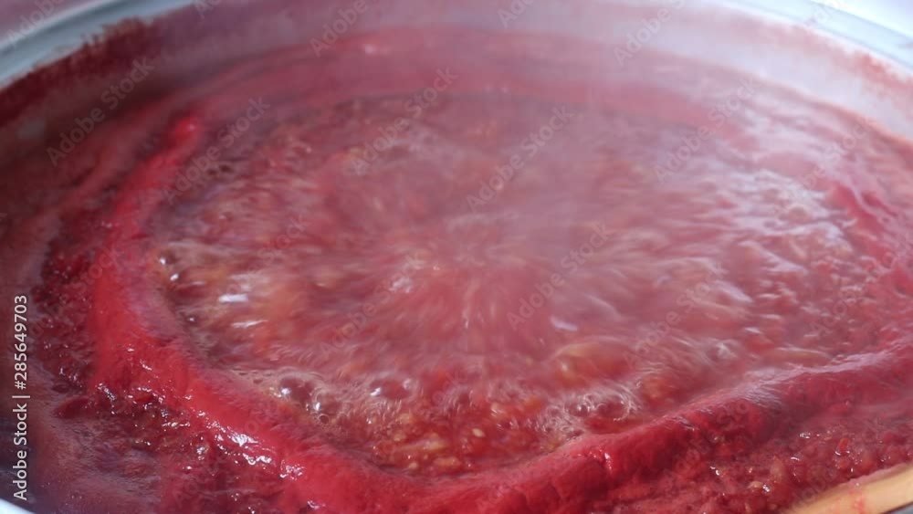 Closeup of boiling tomato, boiling tomato sauce Closeup of boiling tomato, boiling tomato sauce