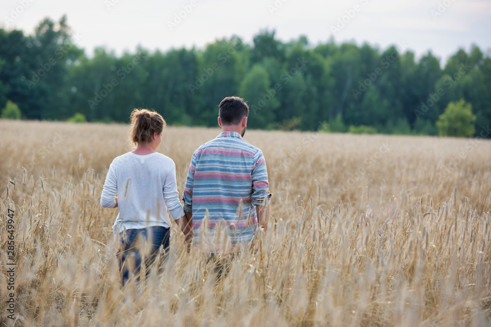 Young Caucasian family walking across field with young girl holding bouquet of flowers, concept organic ecologically friendly family Young Caucasian family walking across field with young girl holding bouquet of flowers, concept organic ecologically friendly family