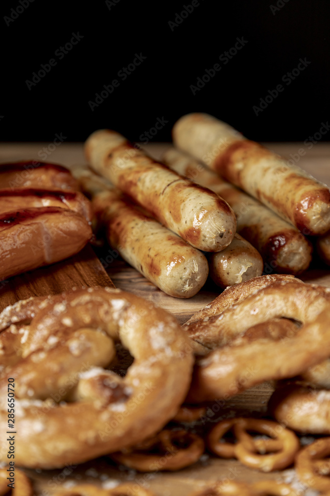 Tasty bratwurst with pretzels on a table Tasty bratwurst with pretzels on a table