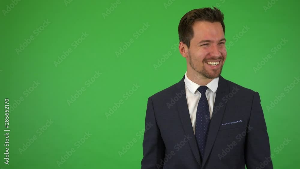 A young handsome businessman celebrates - green screen studio A young handsome businessman celebrates - green screen studio
