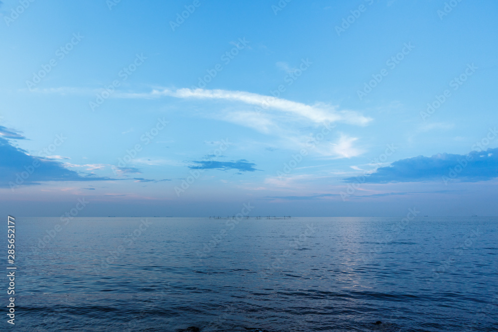 Coastline of the sea in the rays of the setting sun