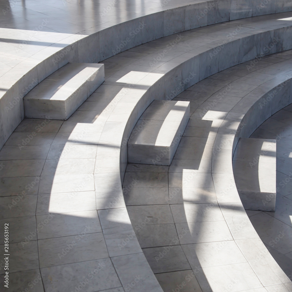Fototapeta premium Dark smooth lines of shadows in a light marble interior