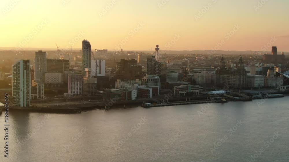 liverpool city aerial view at sunrise rising up from mersey river over waterfront uk england liverpool city aerial view at sunrise rising up from mersey river over waterfront uk england