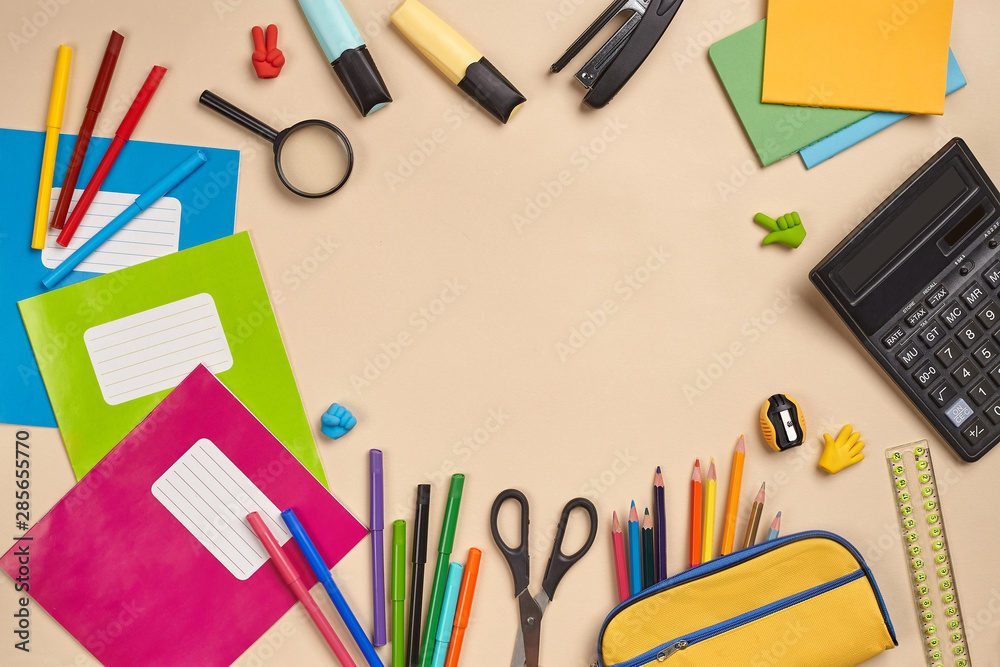Flat lay photo of workspace desk with school accessories or office supplies on pink background. Flat lay photo of workspace desk with school accessories or office supplies on pink background.