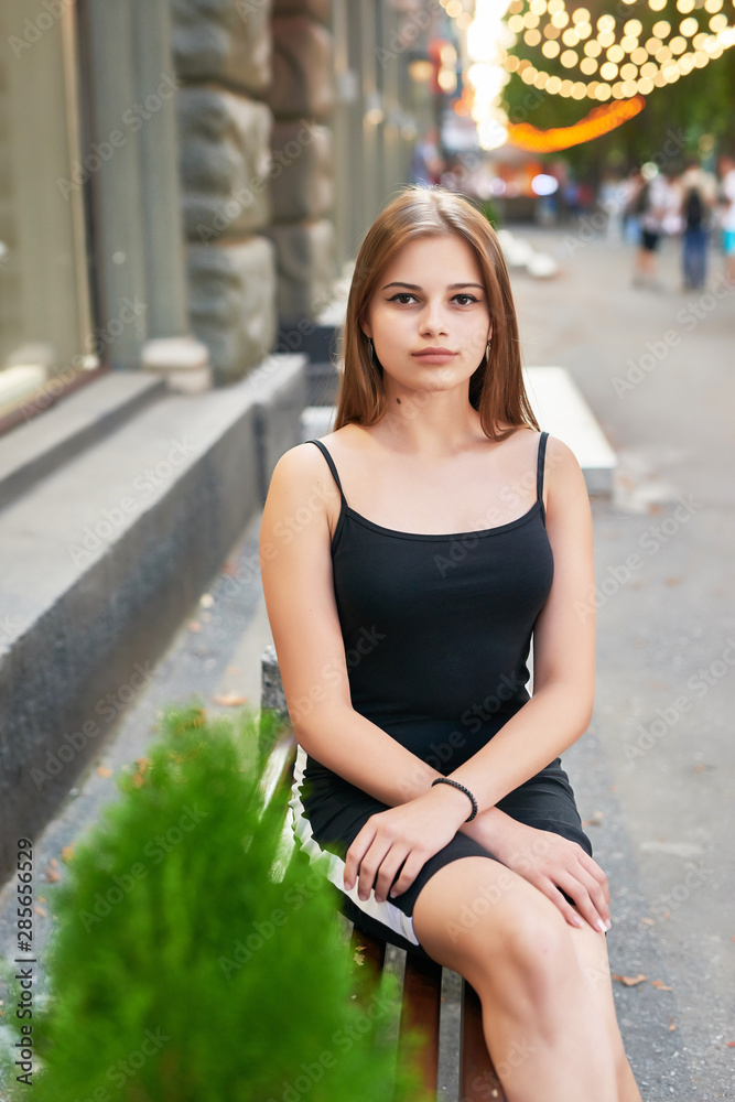 teen girl on a background of lights of garlands teen girl on a background of lights of garlands