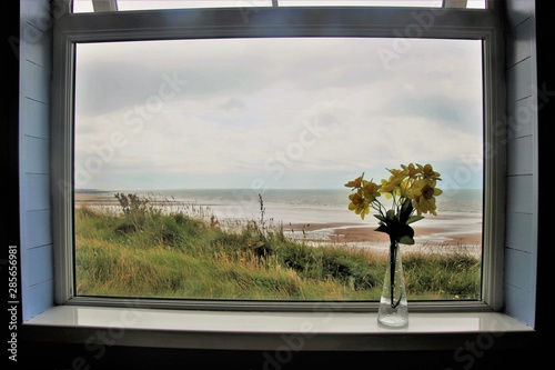 View through a window onto the beach of St Bees. On the west coast of England, near Lake District. North-west Europe.