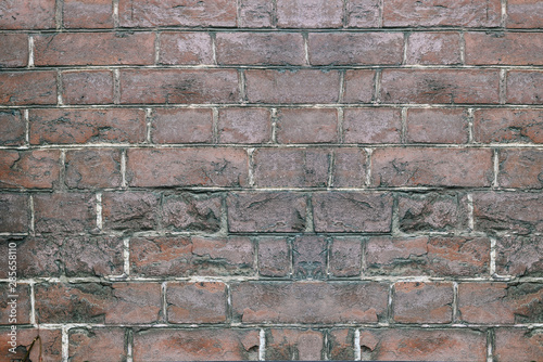 The brick wall is brown. Ancient masonry. The architecture of the city. Bricks close up