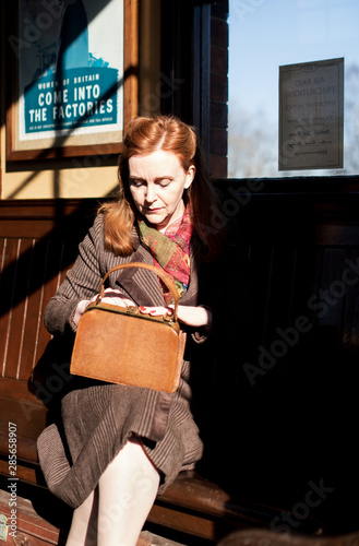 An elegant 40s lady awaits the arrival of ehr train at Quorn and Woodhouse from the comfort of the ladies waiting room.