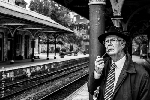 Awaiting his train to Leeds, the Yorkshire businessman smokes his pipe.