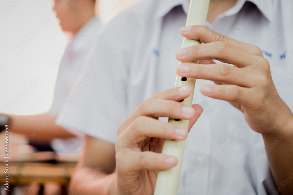 Asian students playing thai flute, some wind instruments in school classroom,  thai music instrument.