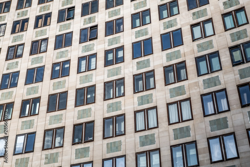 Closeup of Portland stone apartment building facade by London Southbank