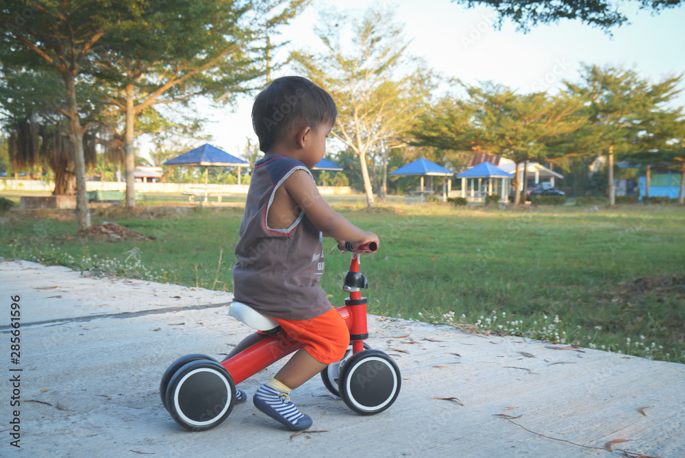 Boy playing a bicycle using a plowed leg is a bike Boy playing a bicycle using a plowed leg is a bike