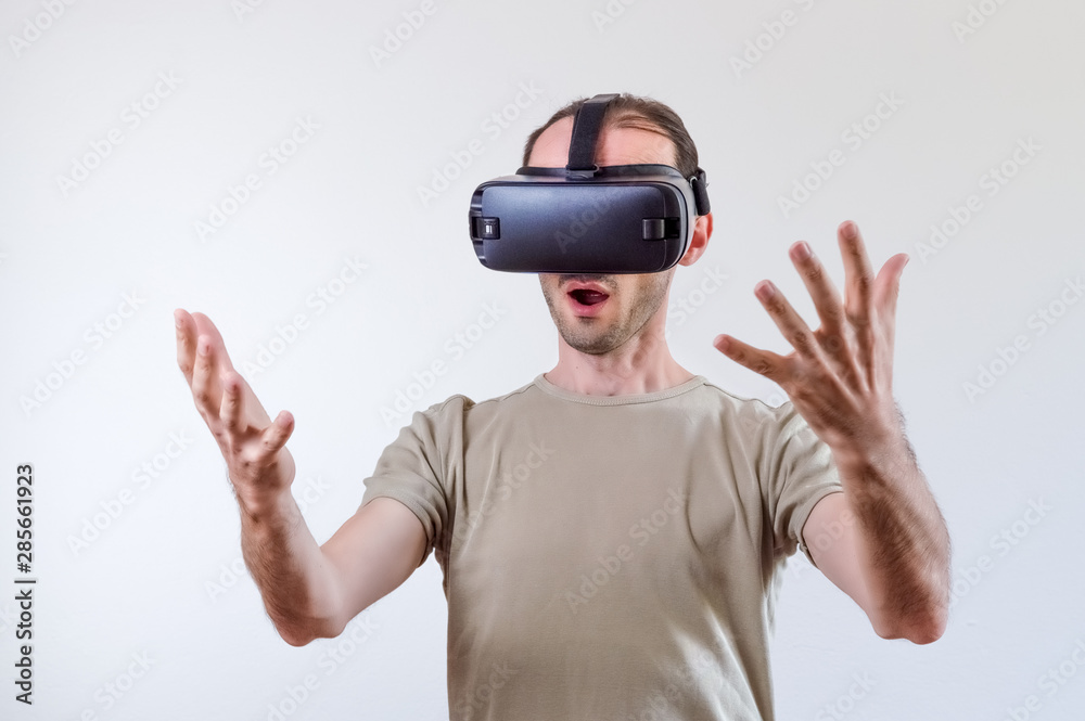 Man exploring modern technology virtual reality with head mounted display on white background Man exploring modern technology virtual reality with head mounted display on white background