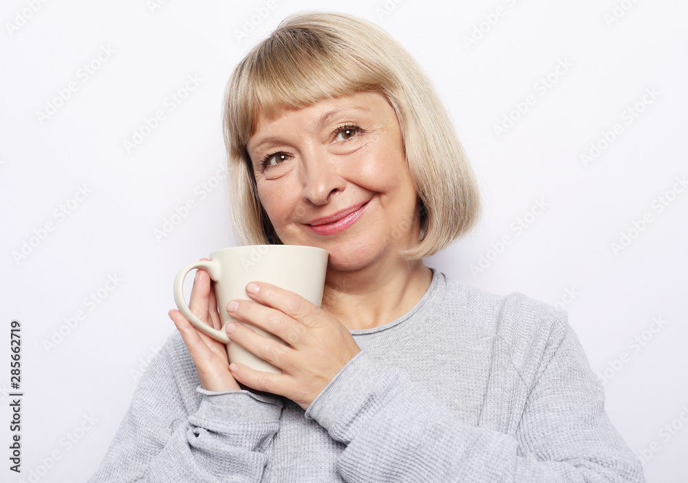 Happy old lady with coffee, isolated on white Happy old lady with coffee, isolated on white