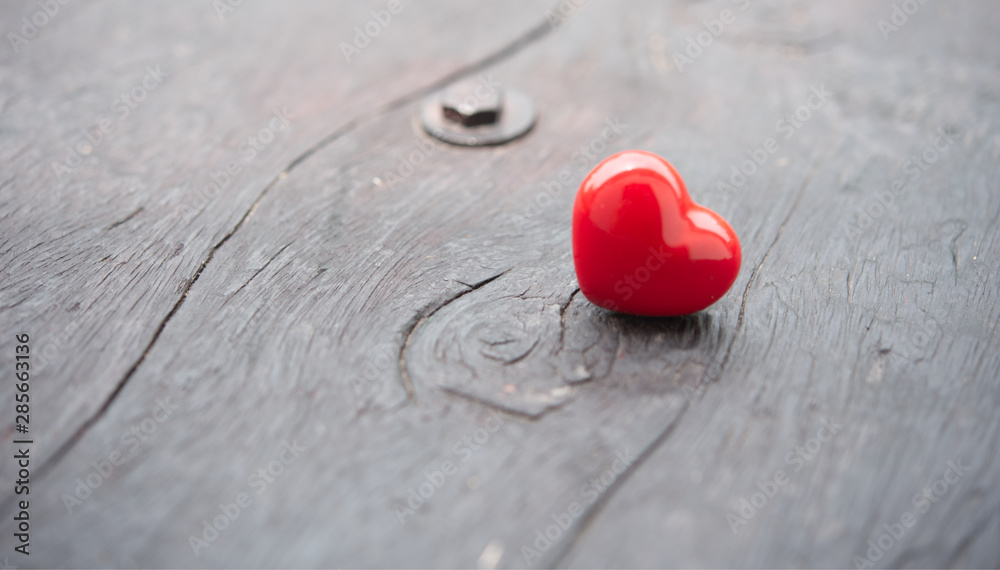 Fototapeta premium Red heart on wooden with soft light.